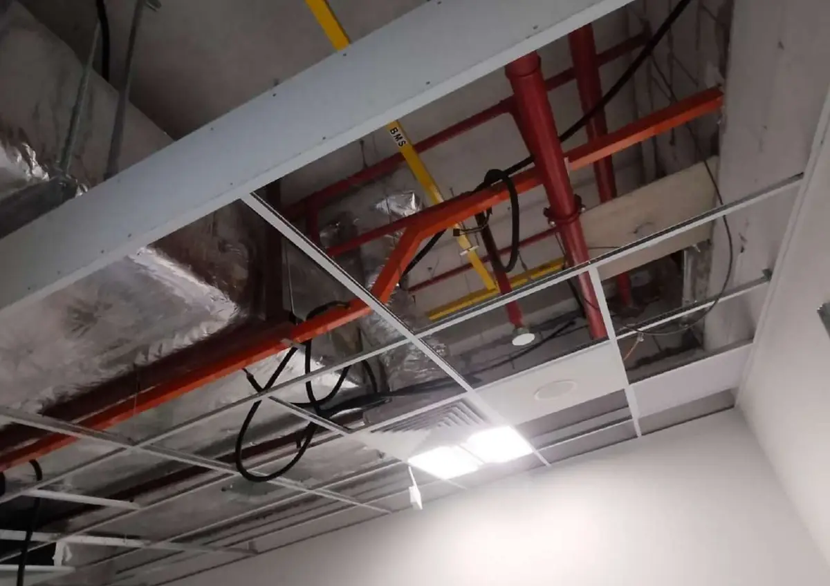 Ceiling piping exposed during reinstatement work