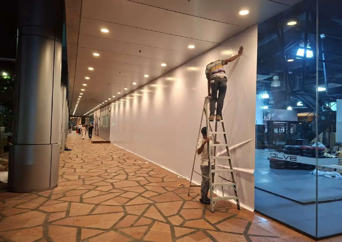 Contractors installing hoarding in a mall